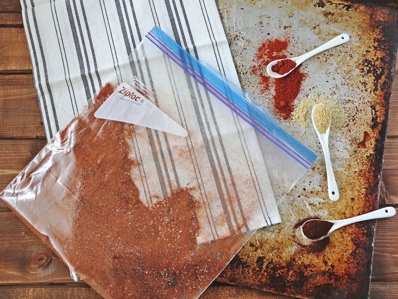 Smoked paprika in Ziplog bag with teaspoons of spices