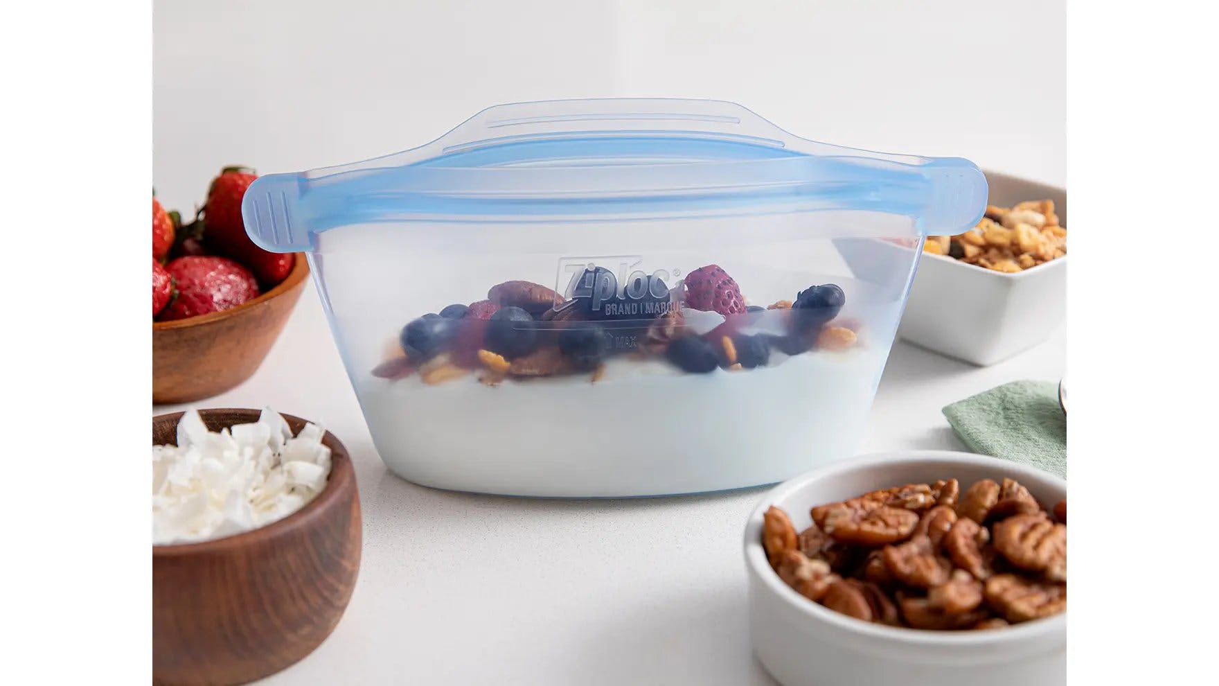 One small Ziploc Endurables container with yogurt, fruits and nuts.