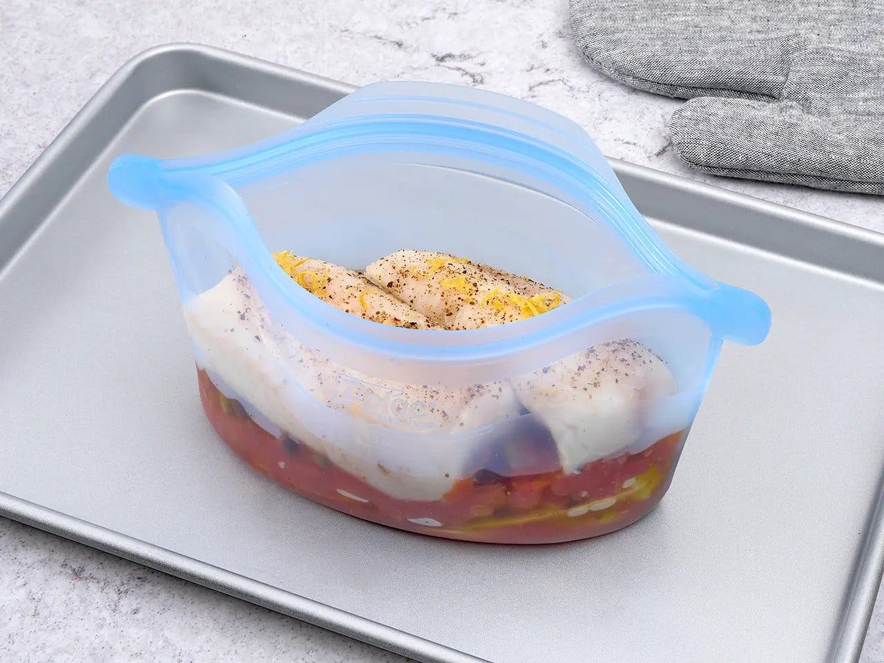 Ziploc® Endurables™ Container of sicilian-style braised Halibut on baking sheet.