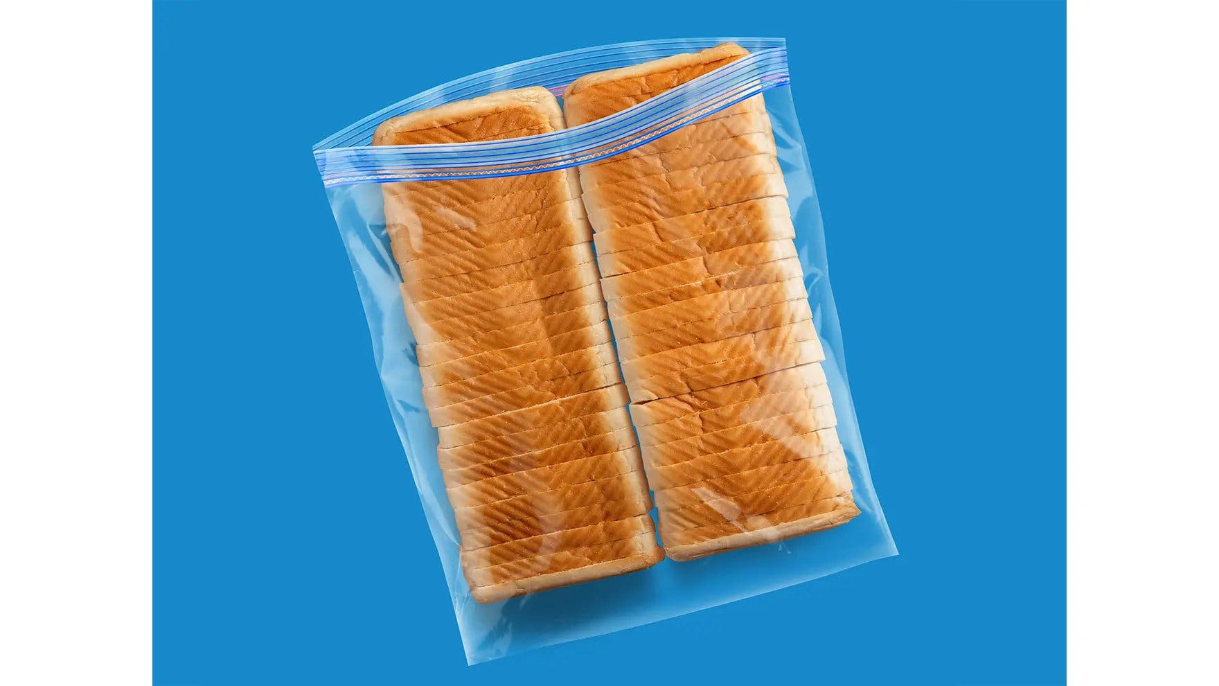 Three loaves of sandwich bread inside an Ziploc® brand extra large freezer bag