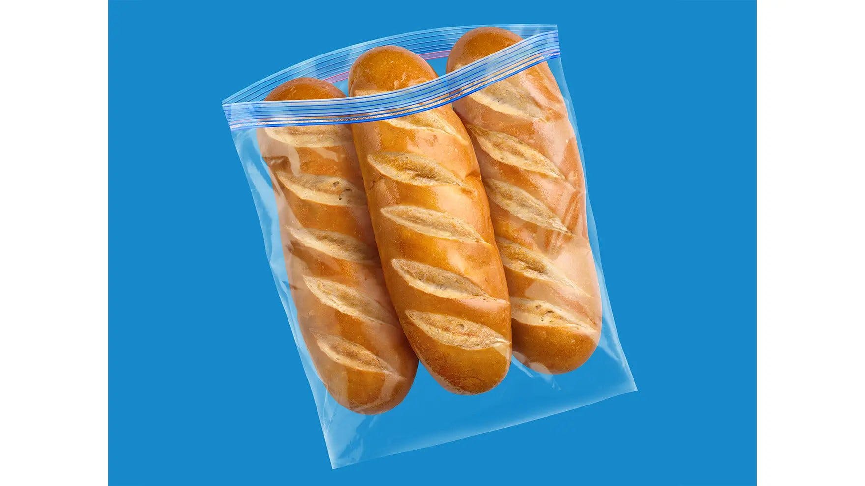 Three loaves of bread inside an Ziploc® brand extra large freezer bag